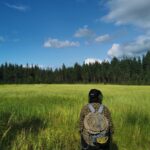 Michael wearing his new outdoor workshirt in an open field surrounded by the woods.