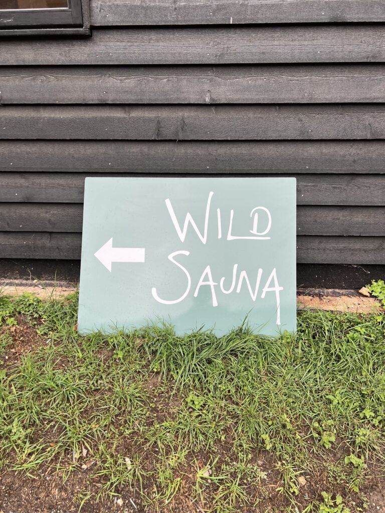 The Wild Sauna sign with an arrow showing which way to walk.